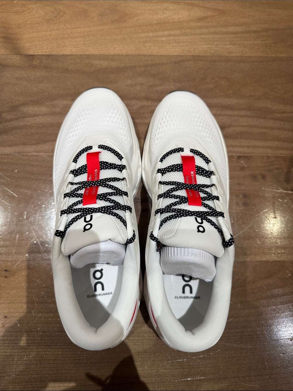 On Running White Athletic Shoes with Red Accent